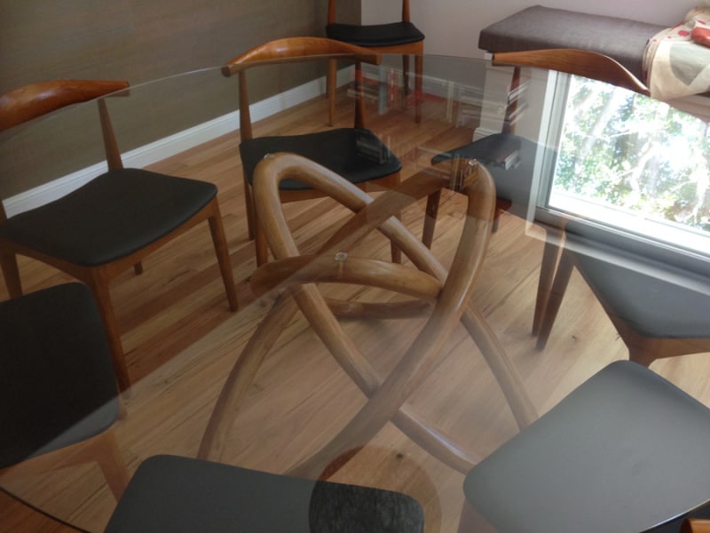 Glass top table with curved legs