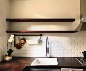 Timber floating shelves matching the kitchen benchtop